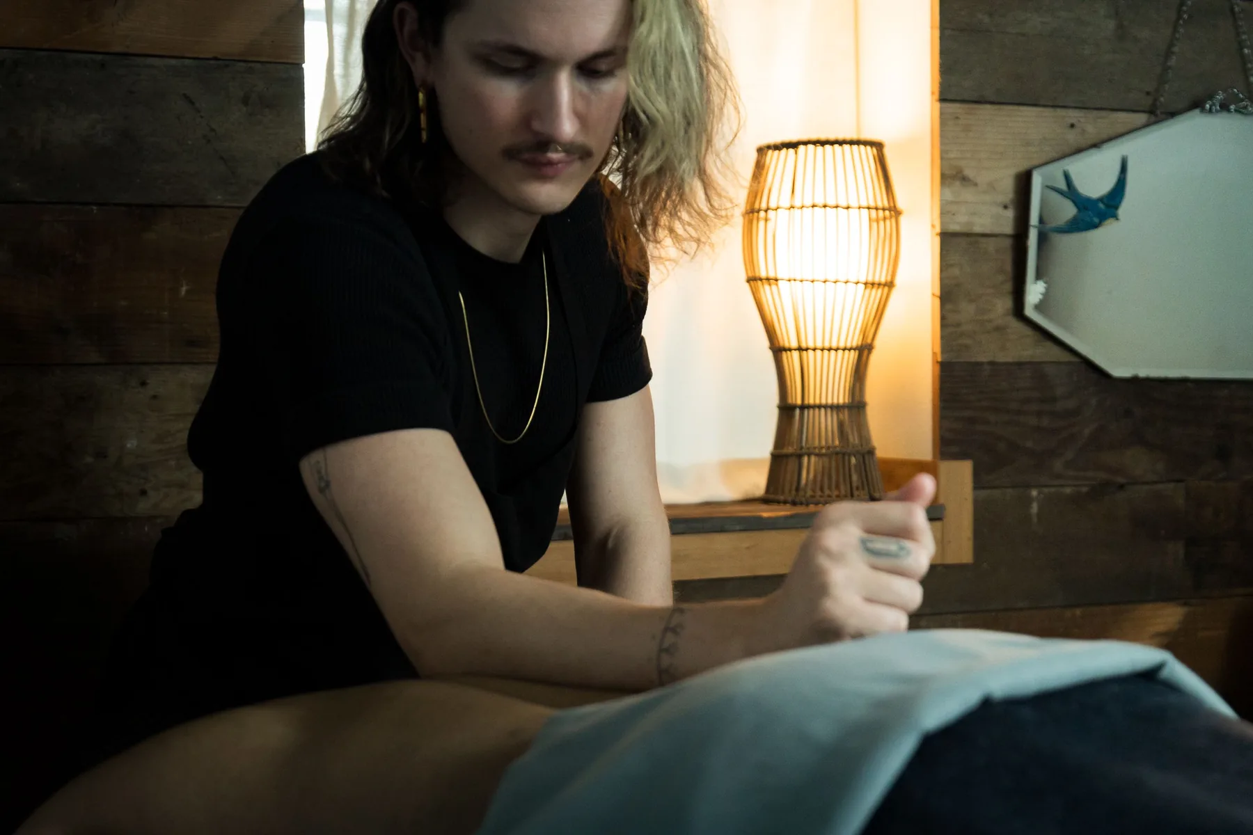 A massage therapist working with a client at Fusion Bodyworks